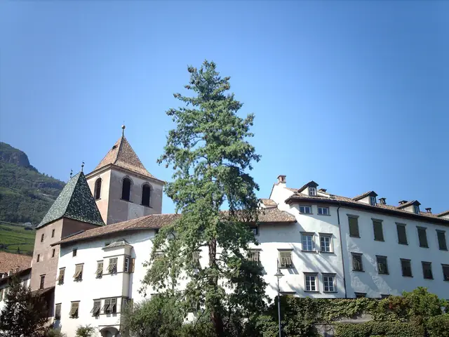 Muri-Gries Abbey in Bolzano: the white abbey buildings and church tower against the mountain
