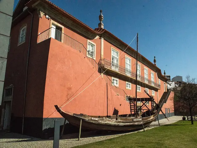 The Museu do Douro in Peso da Régua: the red Casa da Companhia Velha with a rabelo boat on the lawn
