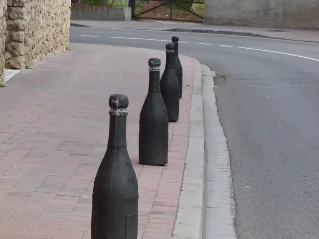 Cava-bottle bollards lining a street in Sant Sadurní d'Anoia, the capital of cava (portrait original)