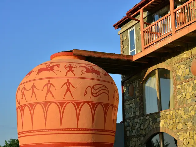 The Twins Old Cellar wine house in Napareuli: a giant painted qvevri beside the stone guesthouse with wooden balconies