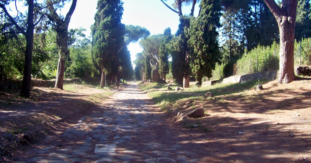 The stone-paved Appian Way outside Rome lined with umbrella pines and cypresses