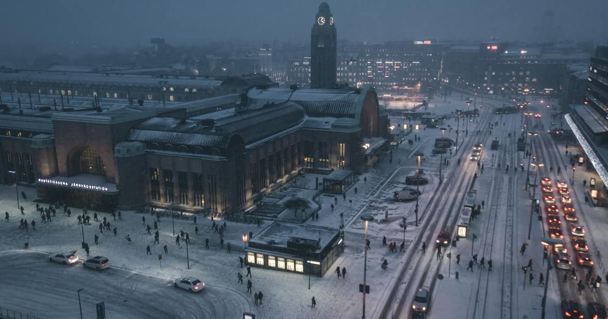 Helsinki railway station and its square in snow at dusk, seen from above